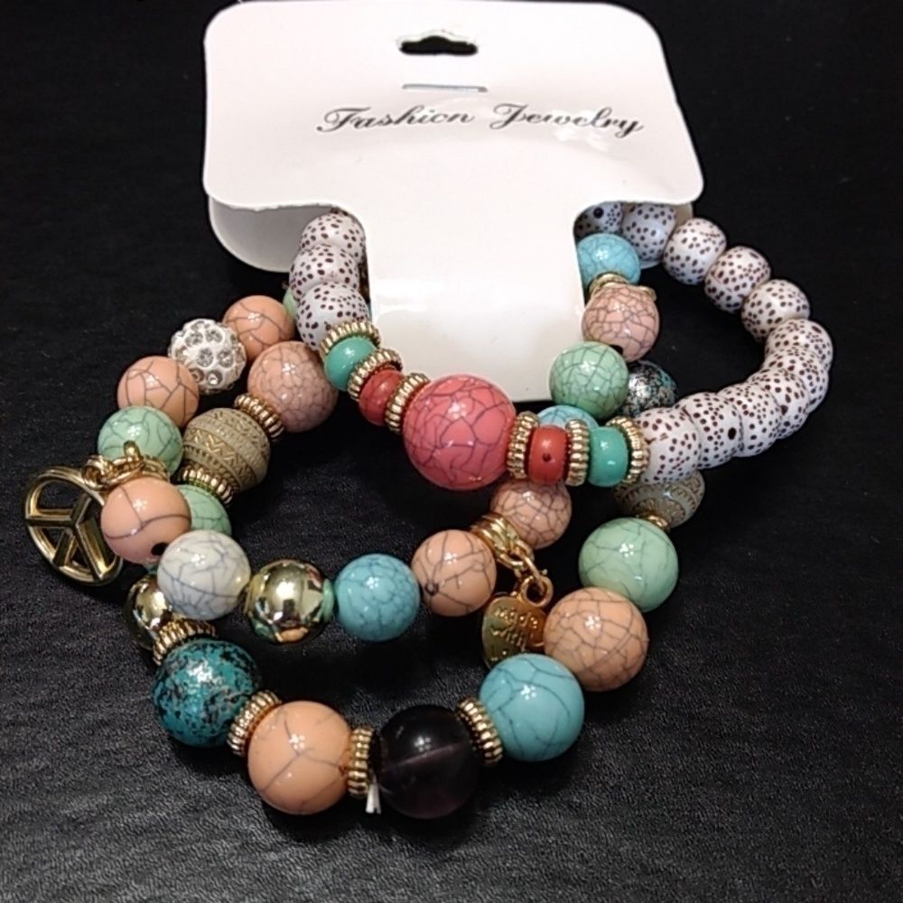 Beaded stretch bracelet trio with peace and star charms 7.25"